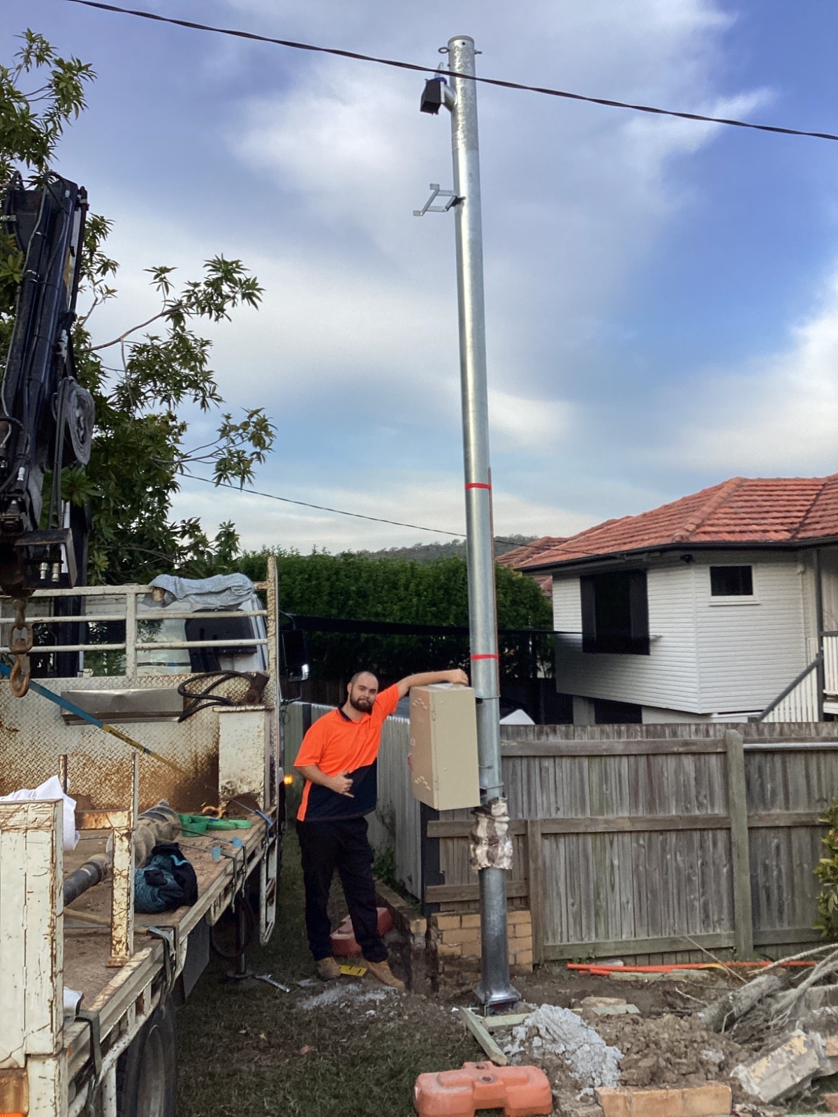 Poles and Holes crew installing a permanent power pole at a Brisbane home
