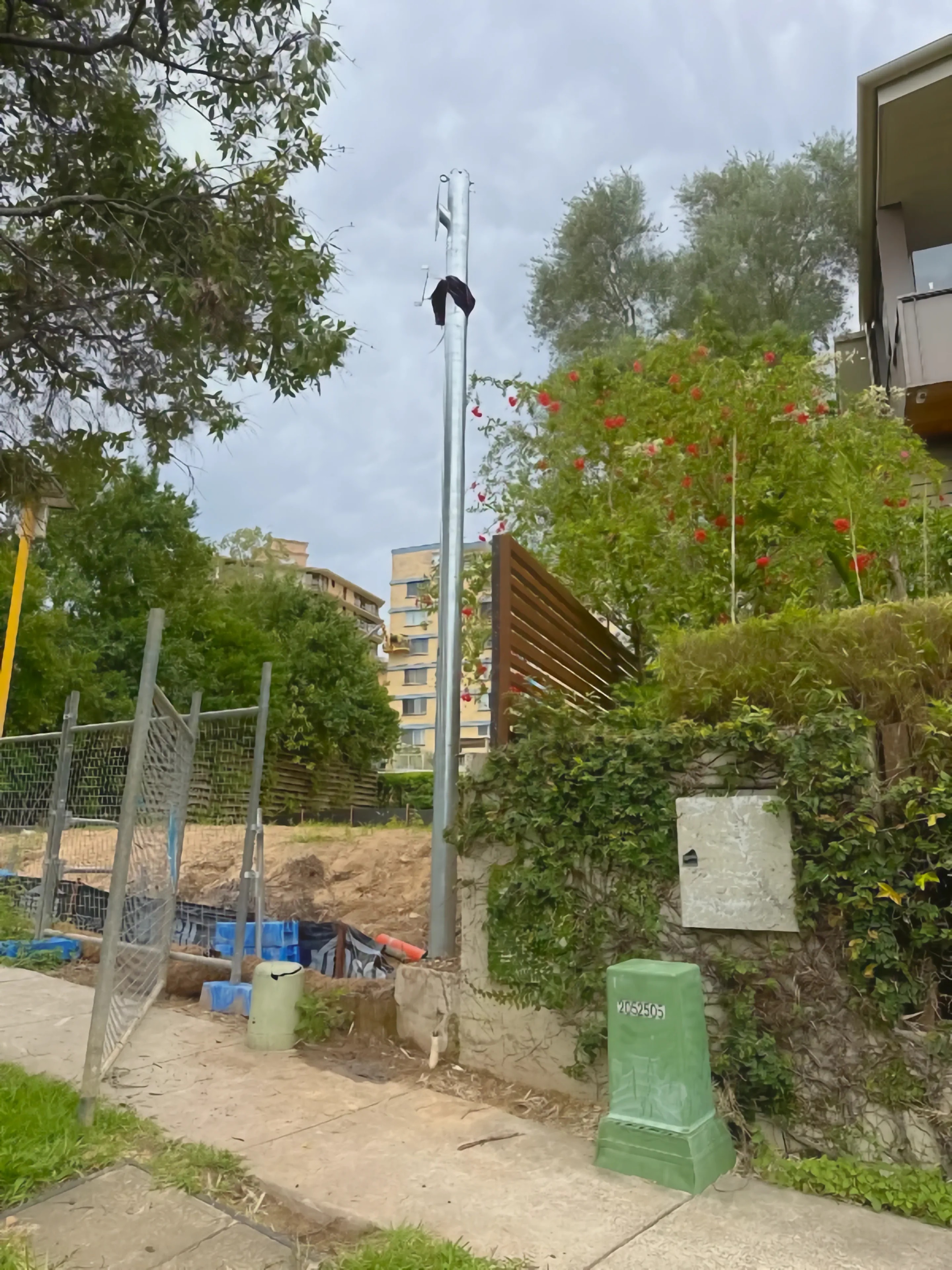 Permanent power pole installed on the verge of a Brisbane property