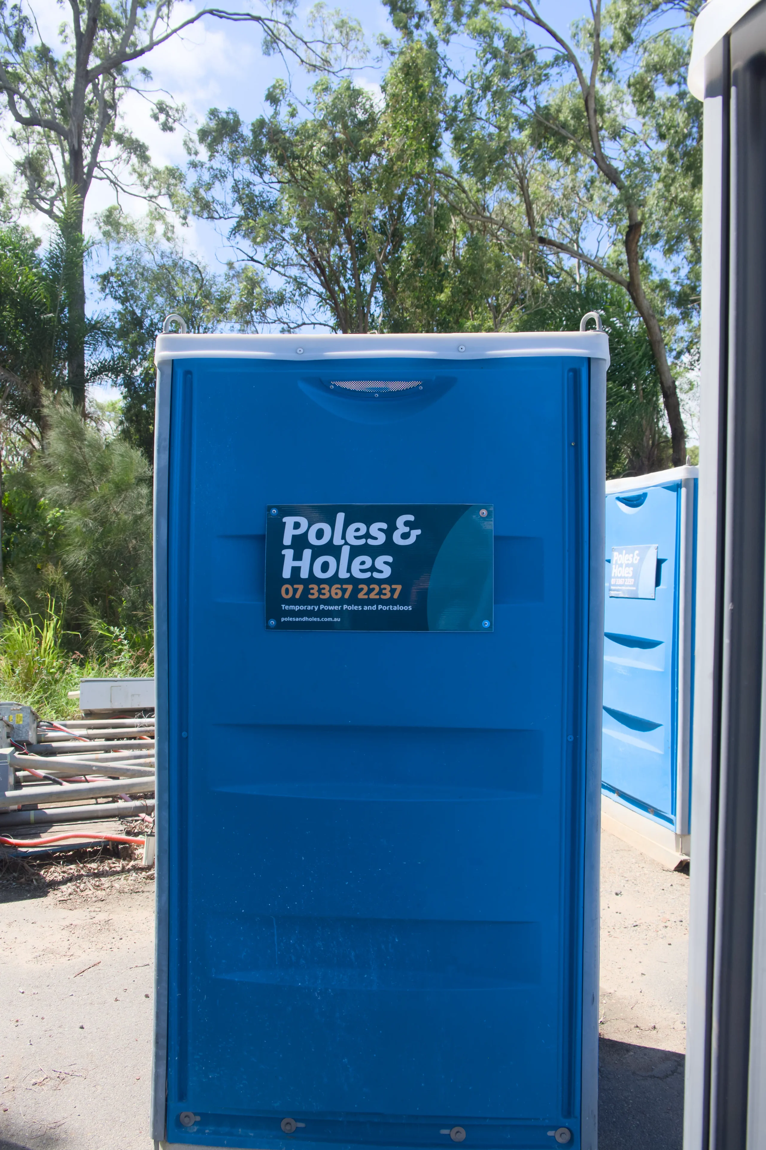 Poles and Holes construction site portaloo, front on